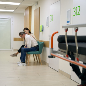 Stressed man and woman waiting at emergency room