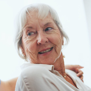 A photo of an elderly woman and a caretaker