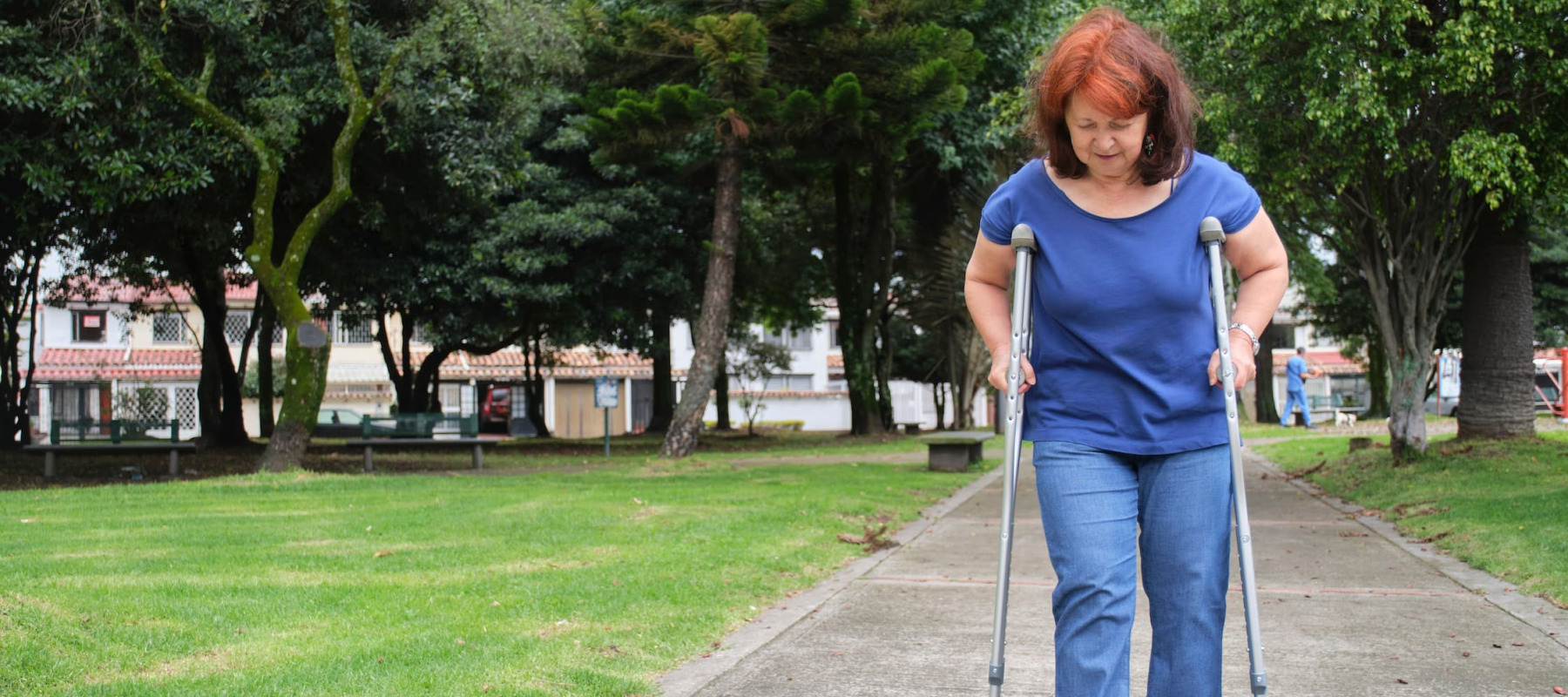 A woman walking on crutches
