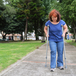 A woman walking on crutches