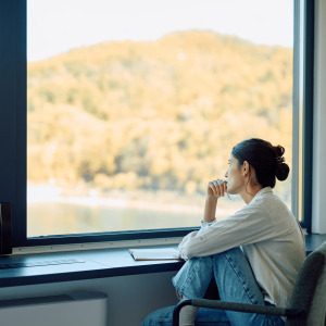 A photo of a woman thinking, looking out of the window
