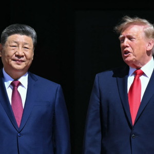 U.S. President Donald Trump stands with China's President Xi Jinping as they arrive to visit the National Archives.