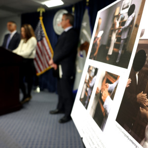 A photo of an alleged fake marriage is seen as Leah Foley, U.S. Attorney for Massachusetts, speaks to reporters during a press conference at the John Joseph Moakley U.S. Courthouse.