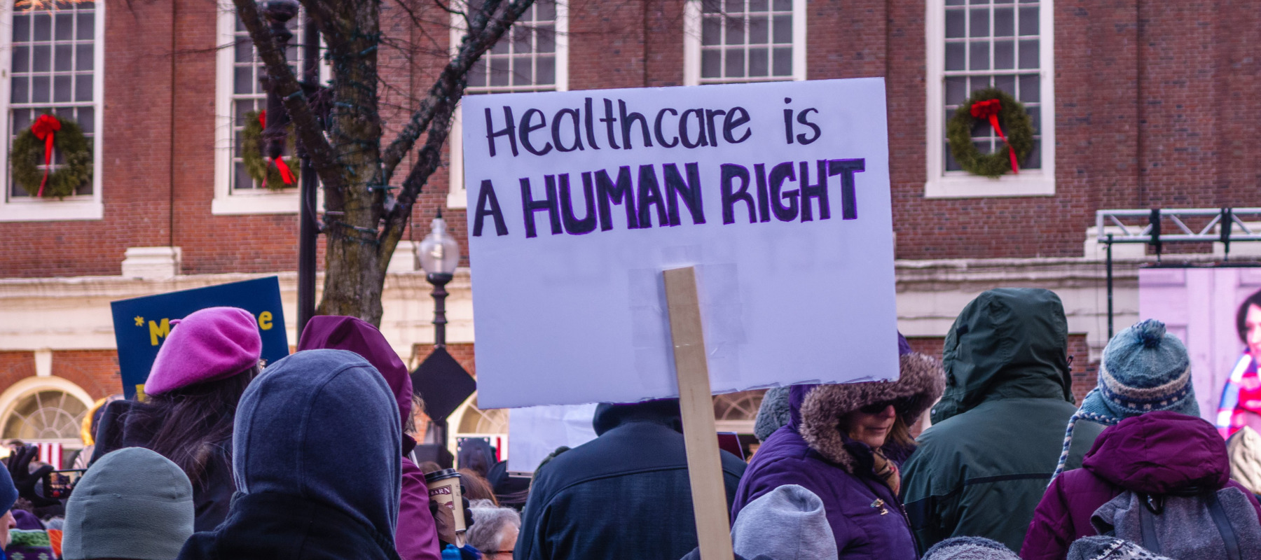 Person holding sign at protest for affordable health care