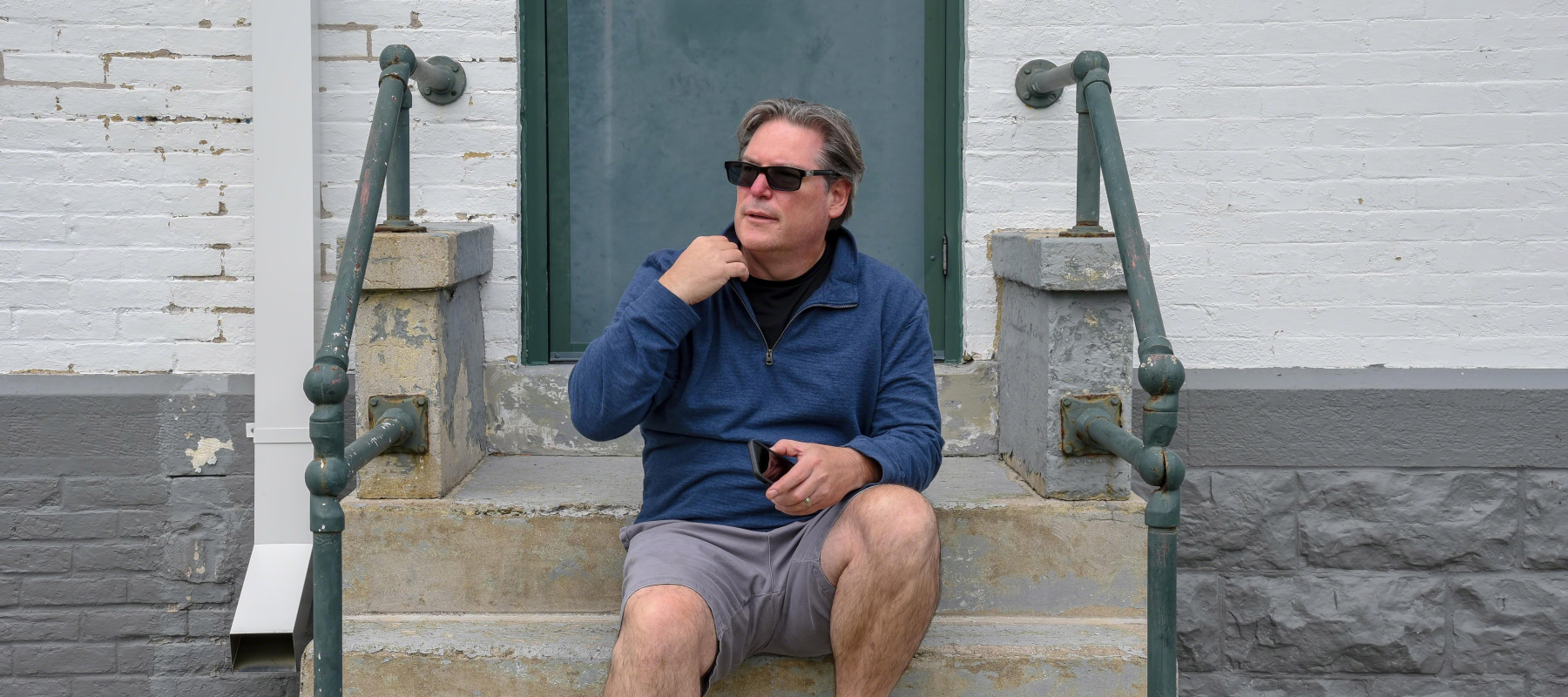Man sitting on apartment stoop