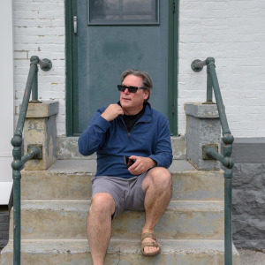 Man sitting on apartment stoop