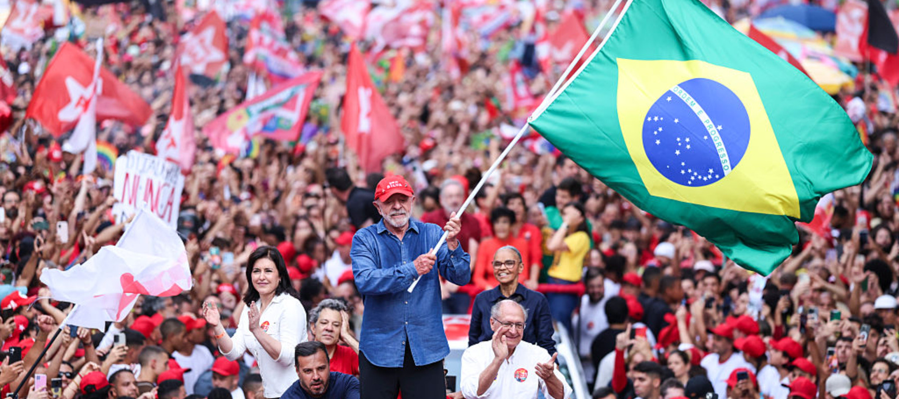 Luiz Inácio Lula Da Silva, incumbent president of Brazil, waves a Brazil flag during a rally