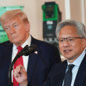 Trump listens as Nvidia CEO Jensen Huang speaks in the Cross Hall of the White House.