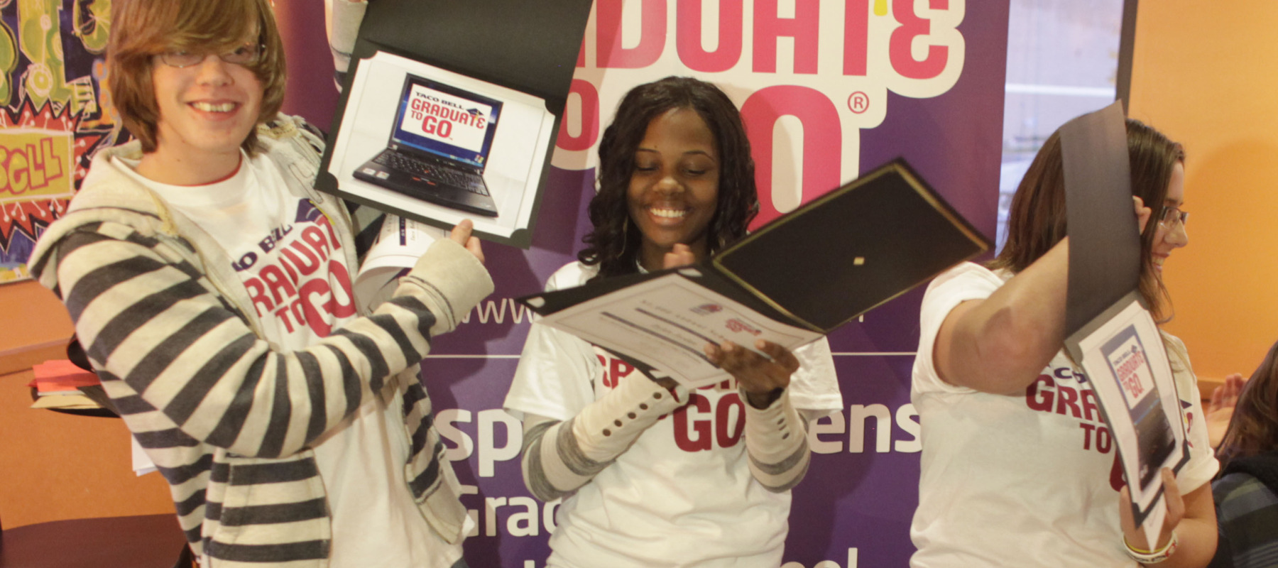 Three Taco Bell scholarship winners, who were also given laptop computers as part of the award.