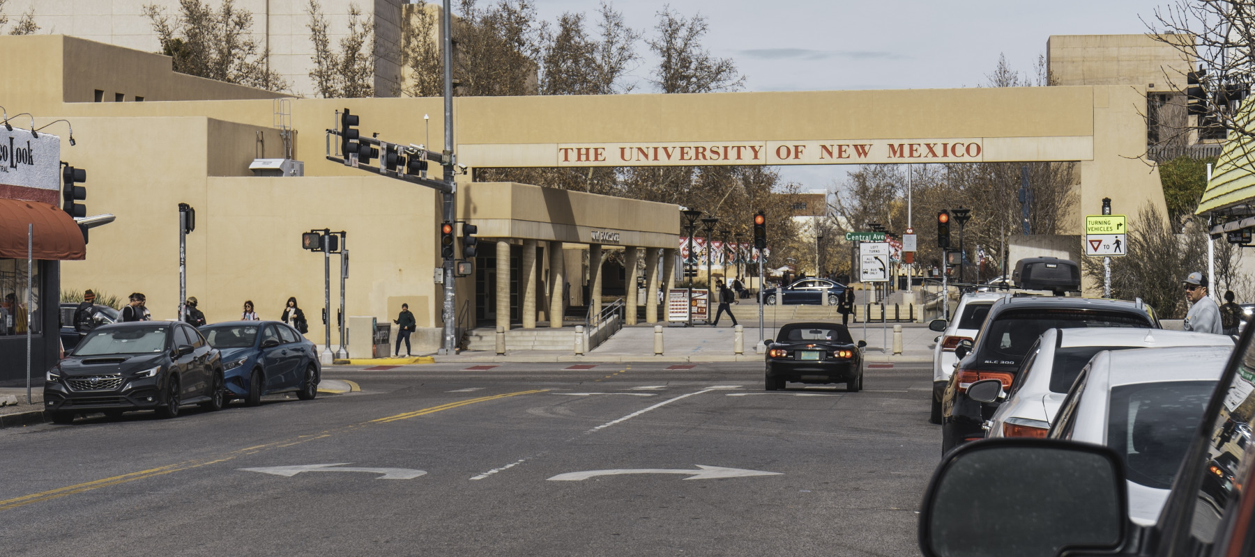 Image of the exterior of New Mexico University Hospital. Also pictured is some ongoing traffic.