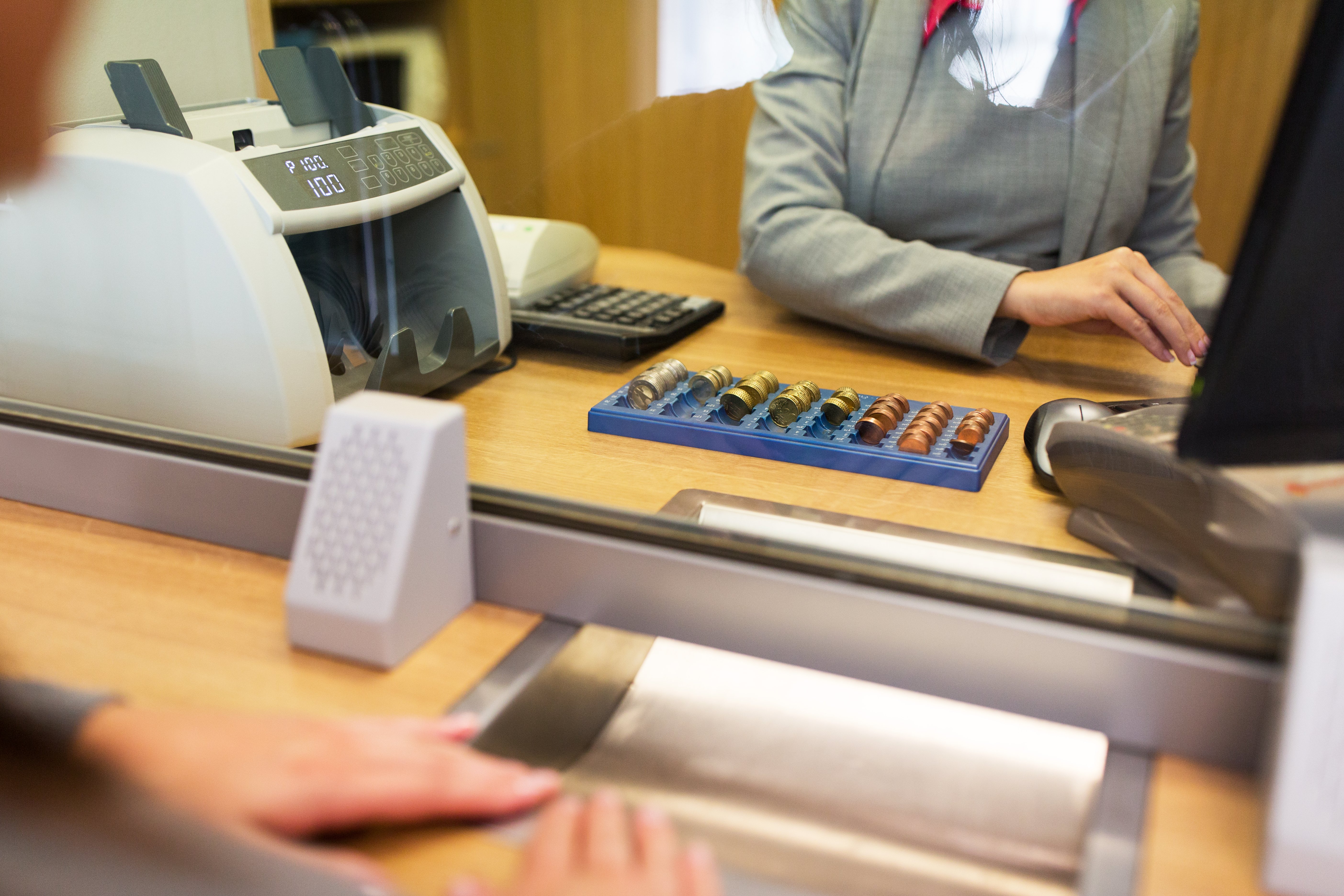 Female hand with money in cash department window. Currency exchange concept