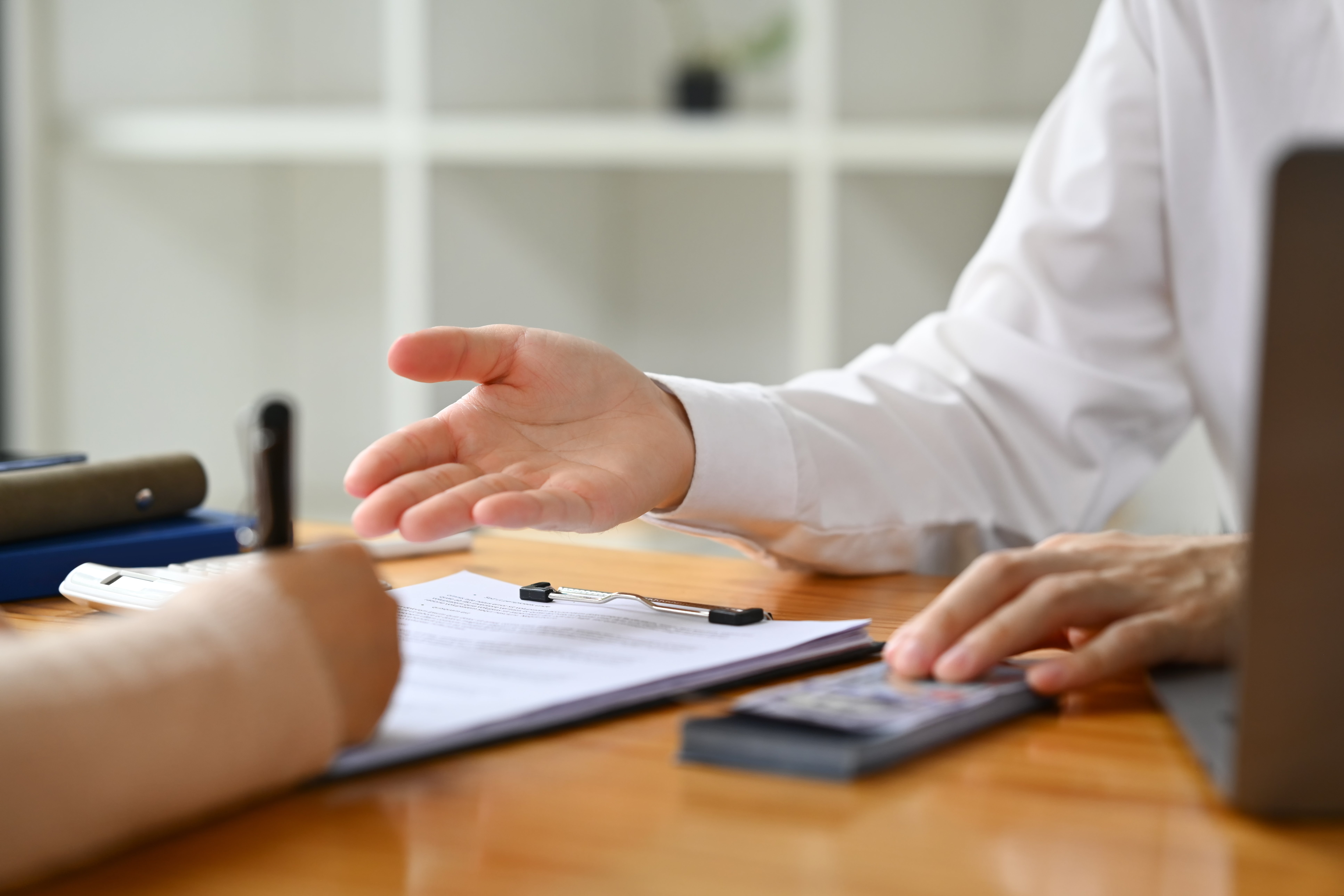 Cropped image of male bank manager broker or financial advisor consulting a client at office