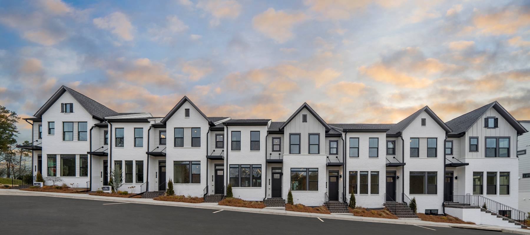 Image of exterior of semi-detached homes on a sunny day.