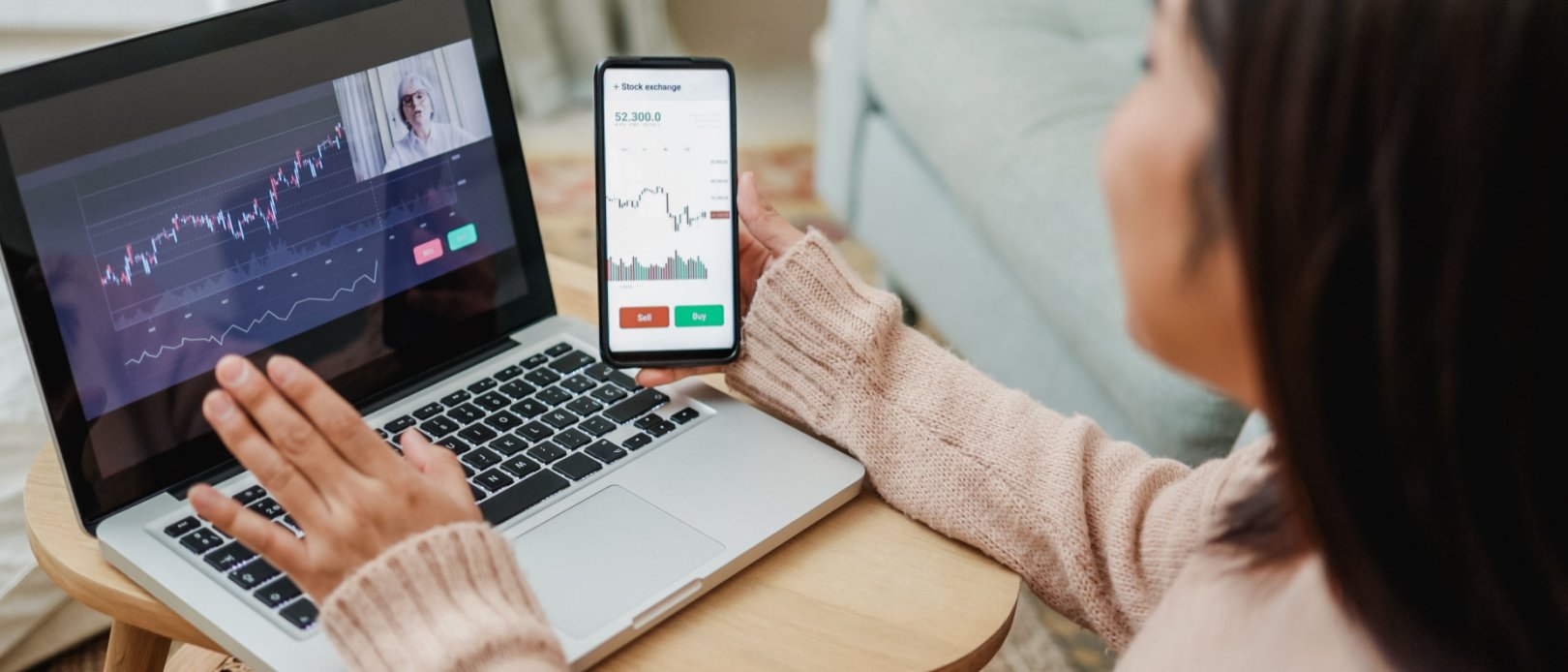 Woman on laptop looking at investments