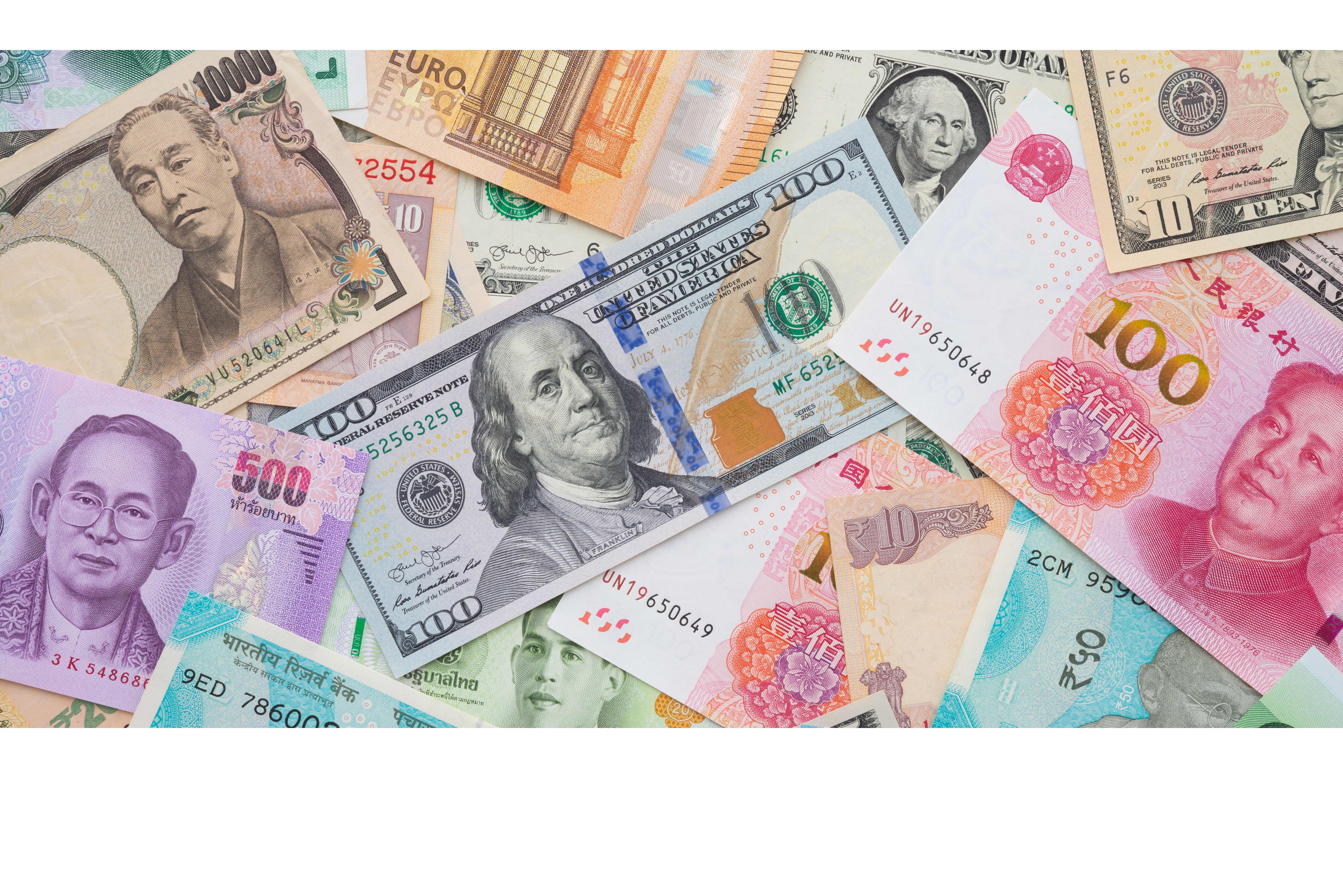 Flat lay or top view of world international banknotes vary countries background. US Dollar, Chinese yuan, Japanese yen, Euro, Indian rupee, Thai baht. Concept of Forex or global financial economic.