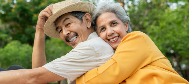 Portrait of an older couple outside.