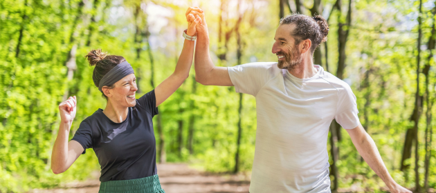 A couple jogging and running outdoors in nature.
