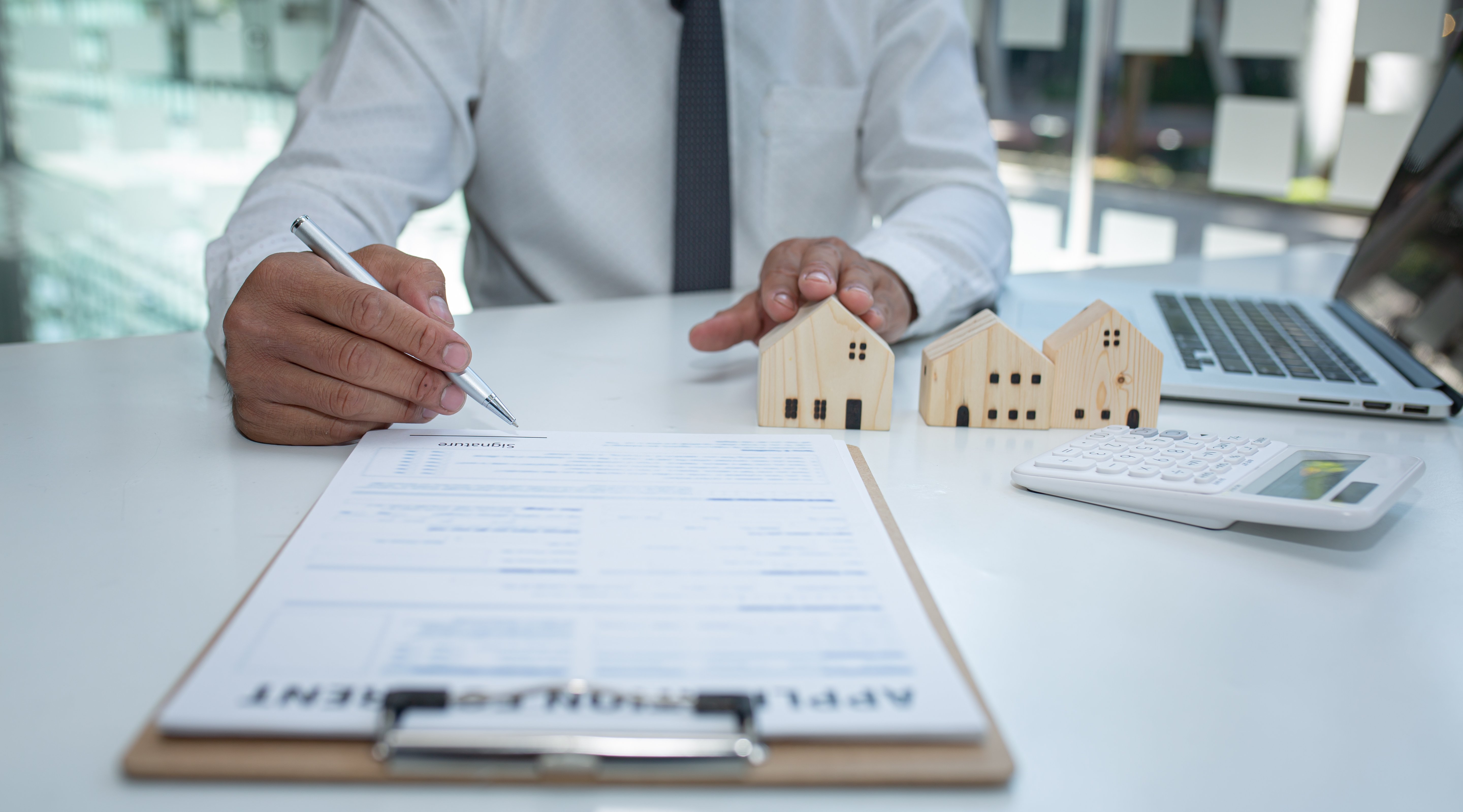 Man signing mortgage agreement