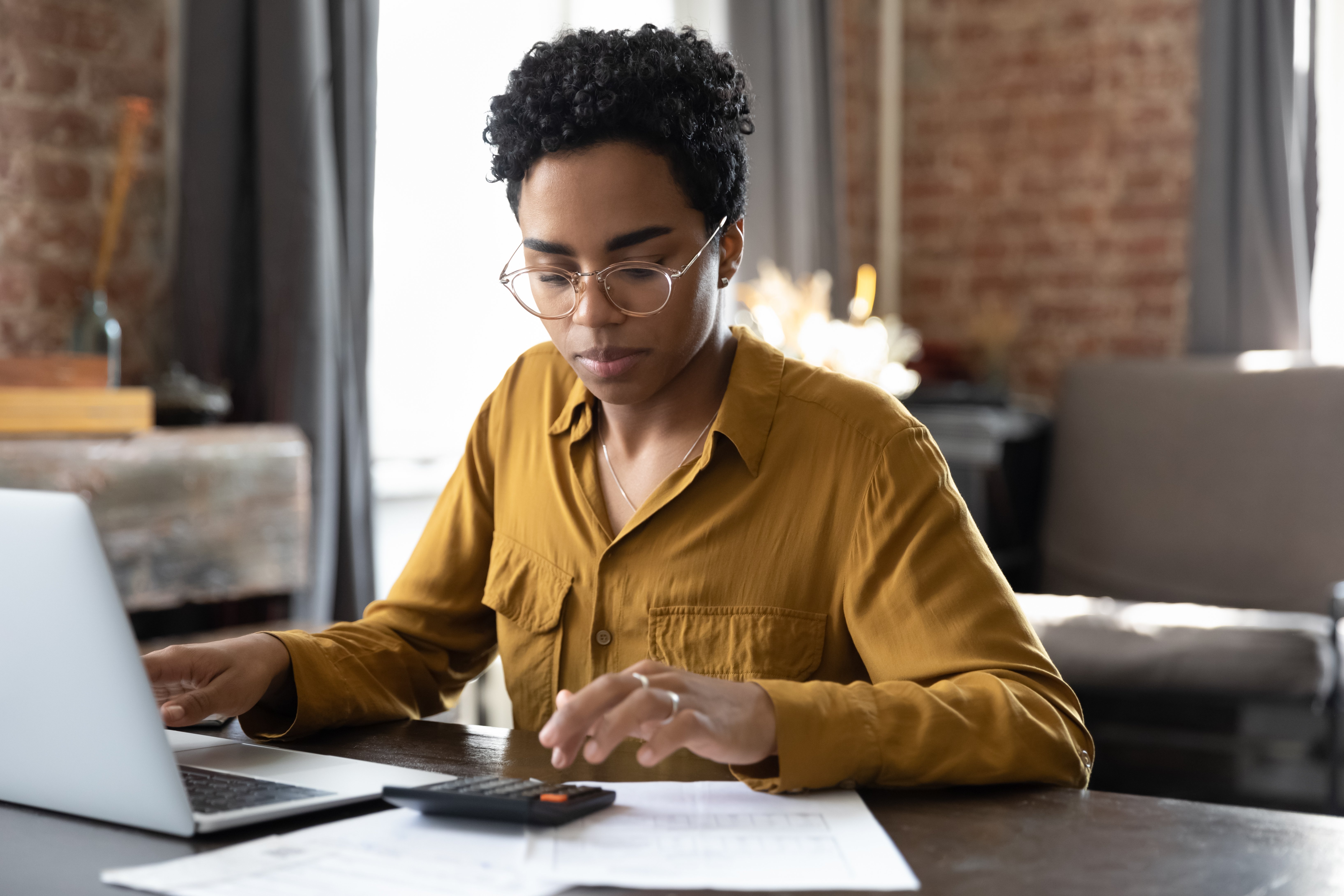 Young woman working on her taxes on her laptop