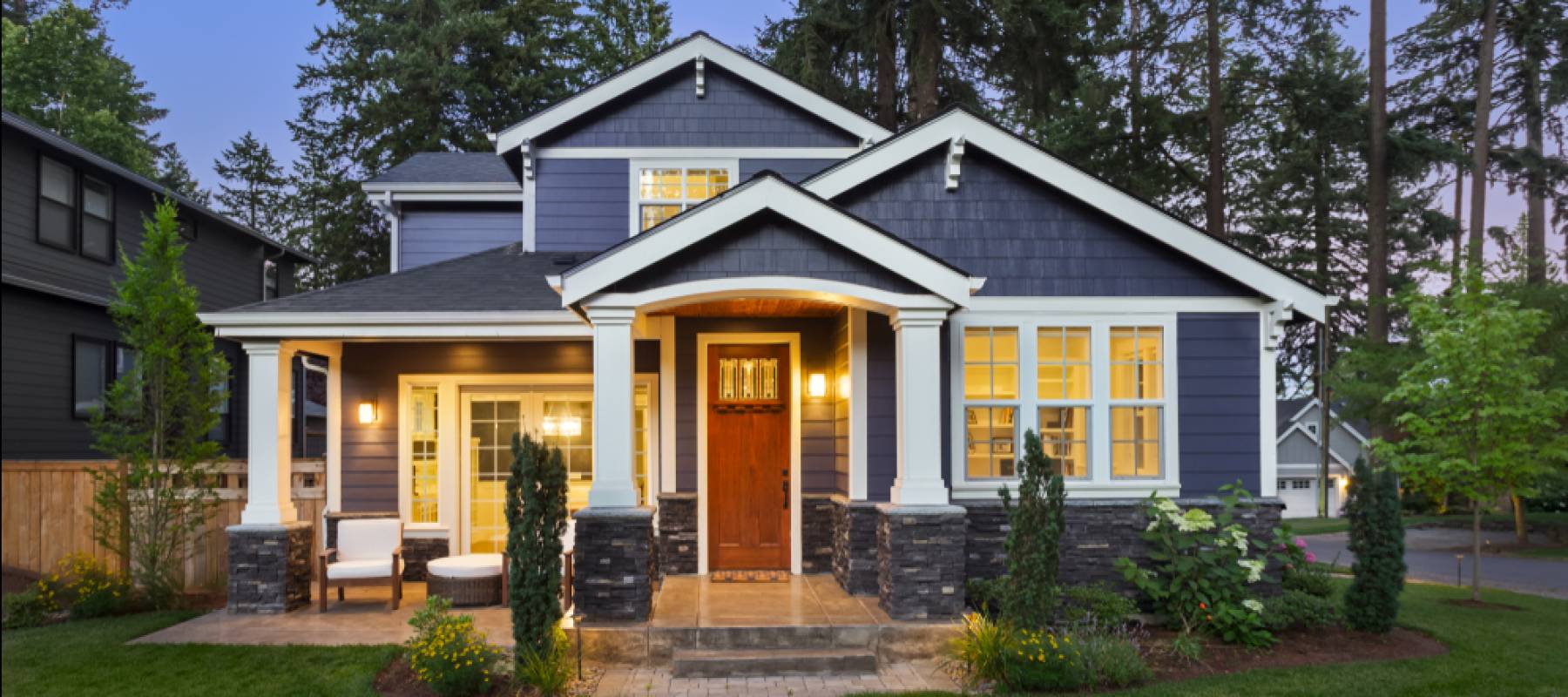Home with luxury exterior with green grass at twilight.